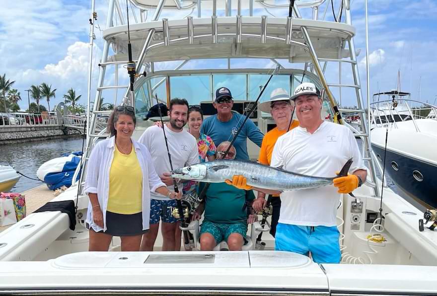 Anglers showing off a wahoo caught during a fishing trip