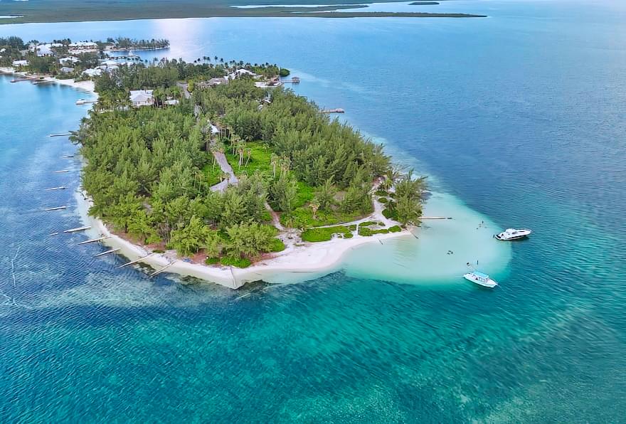 Aerial view of a white sandy beach, a boat tour is how to get to Starfish Point in Grand Cayman