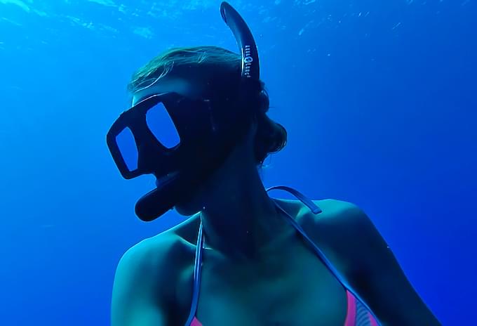 Snorkeler diving deep into the waters of the Cayman Islands