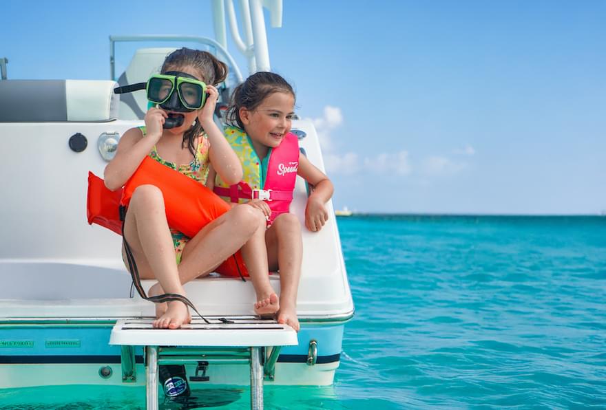 Kids on a boat, gearing up for a fun snorkeling adventure