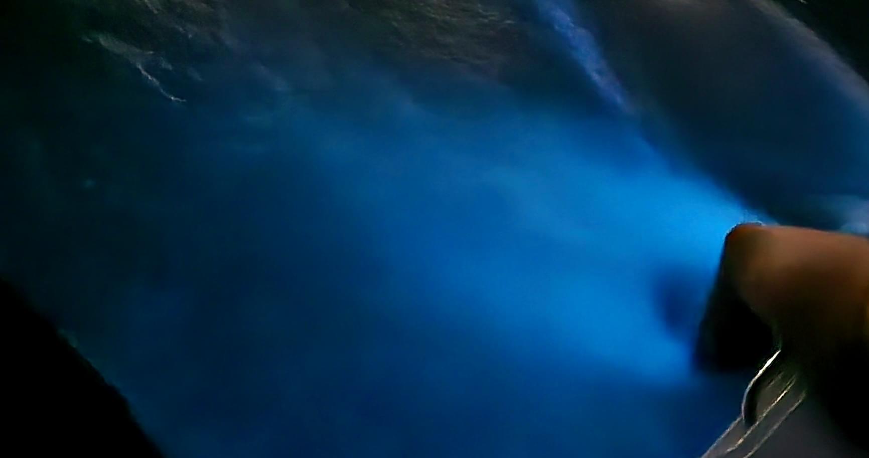 Glowing bioluminescence Grand Cayman on the surface of Cayman Islands water.