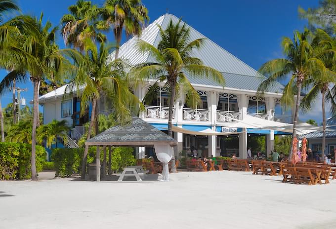 Kaibo Beach Bar’s white sandy beach with oceanfront dining in Grand Cayman