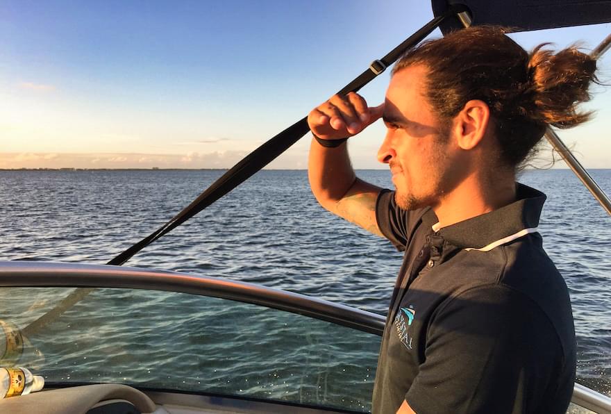 Captain enjoying the scenic sunset during a cruise.