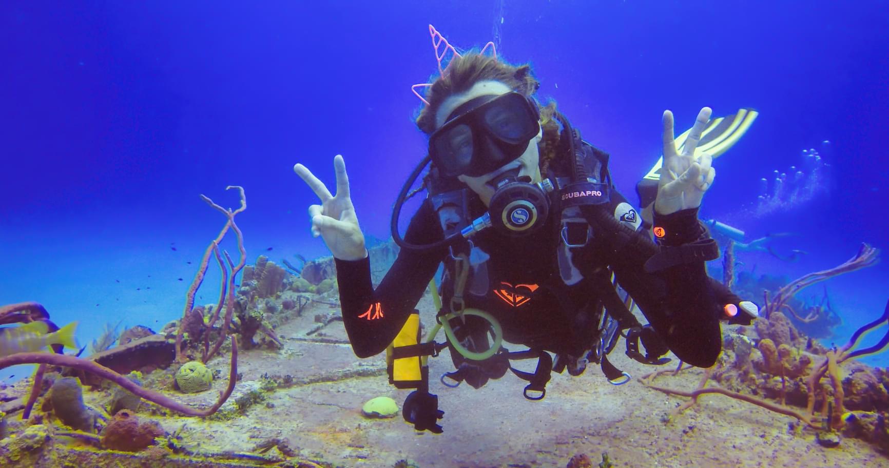A diver exploring the diverse marine life and coral reefs in Grand Cayman waters