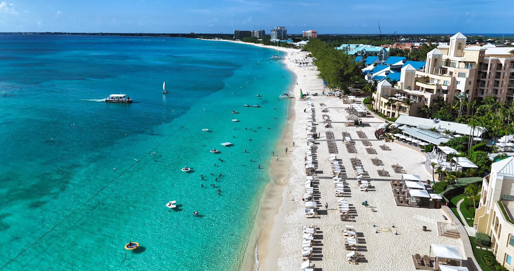 Aerial view of Seven Mile Beach, showcasing pristine sand and turquoise waters in Grand Cayman, the best time to visit Grand Cayman