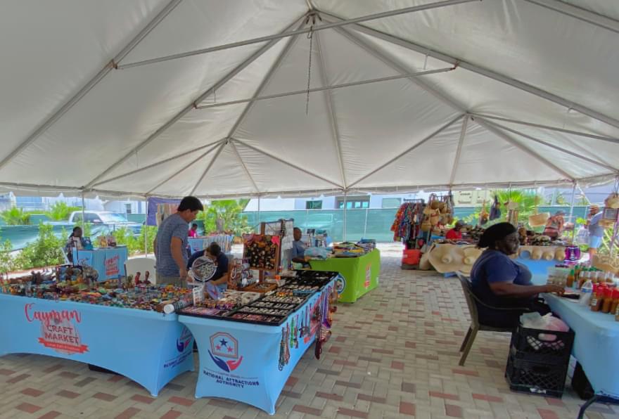 Local market with fresh produce and crafts in George Town, highlighting authentic island culture