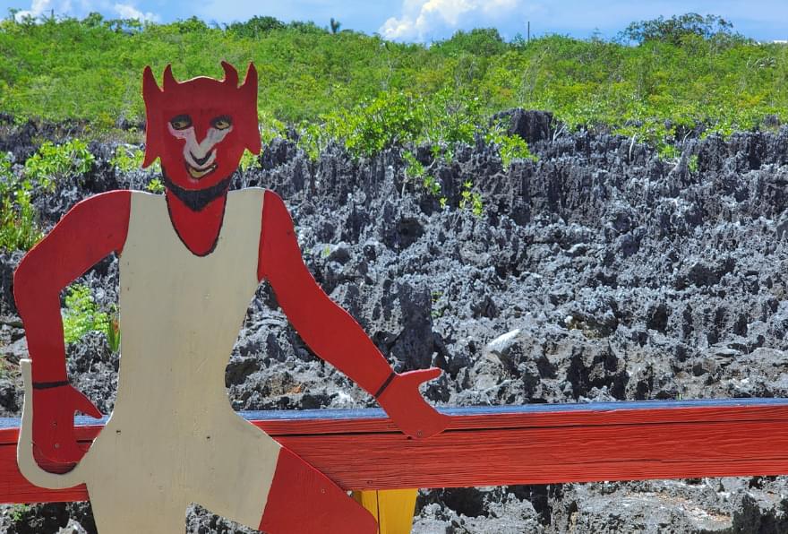 Hell’s unique limestone formations with a red devil statue are marked on a map of the Cayman Islands