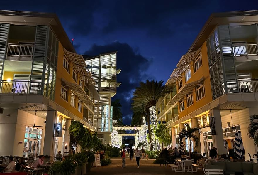 Nightlife at Camana Bay, with illuminated streets and restaurants, is highlighted on a map of Cayman