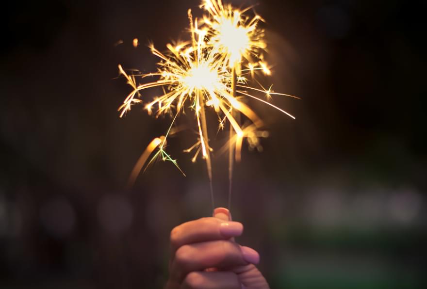 A sparkler lit up during a festive evening celebration in the Cayman Islands