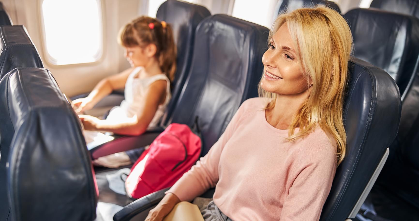 Passengers relaxing on a plane, enjoying the short flight from Miami to Grand Cayman flight time