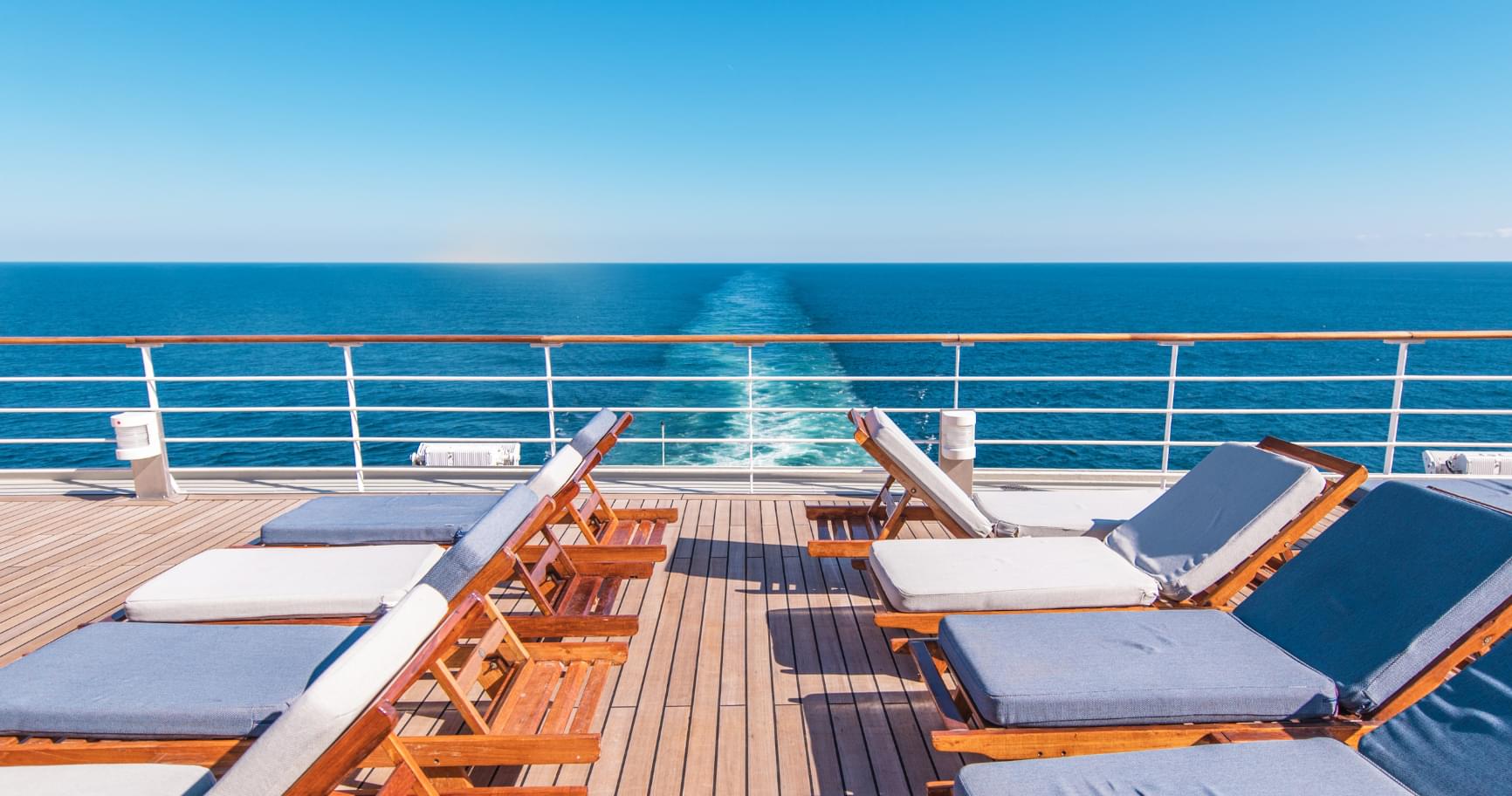 Lounge chairs on a cruise ship deck are perfect for travelers curious about other ways to get to the Cayman Islands