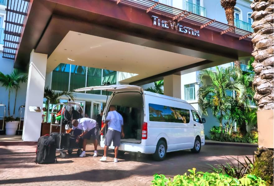 The hotel shuttle van outside the Westin Grand Cayman resort showcases convenient Grand Cayman airport transfer options