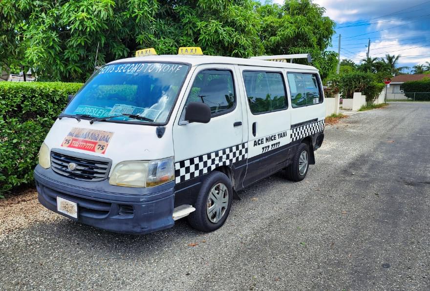 A private minivan parked in a scenic neighborhood, perfect for personalized Grand Cayman taxi service