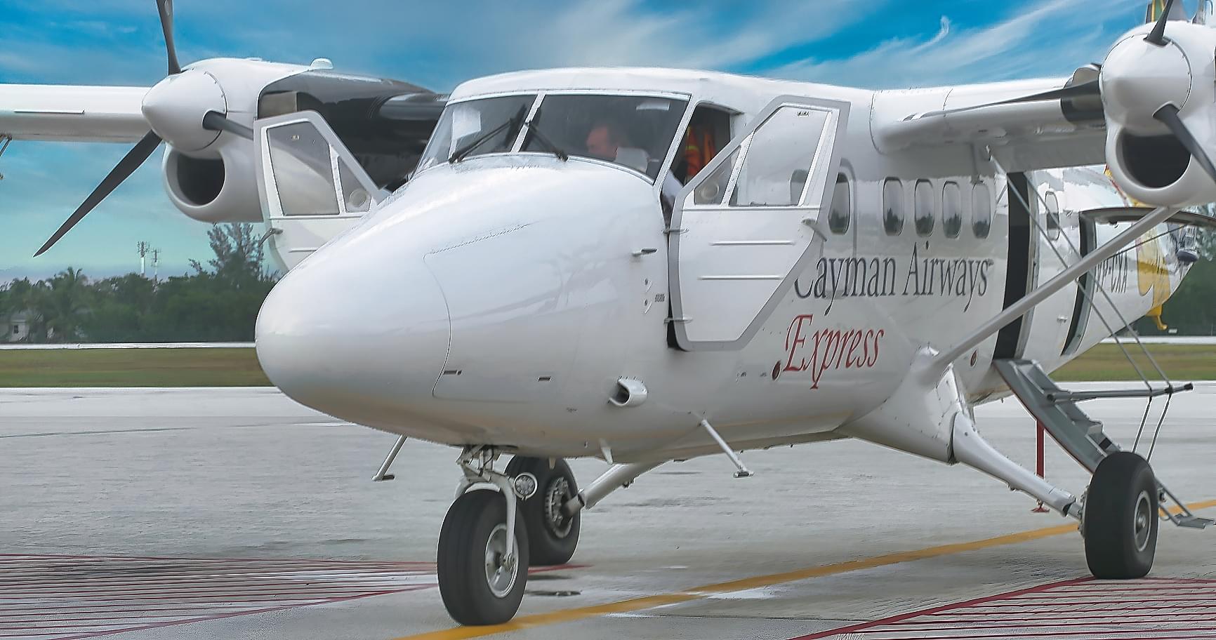 A small inter-island plane parked on the tarmac, ready for short flights between the Cayman Islands
