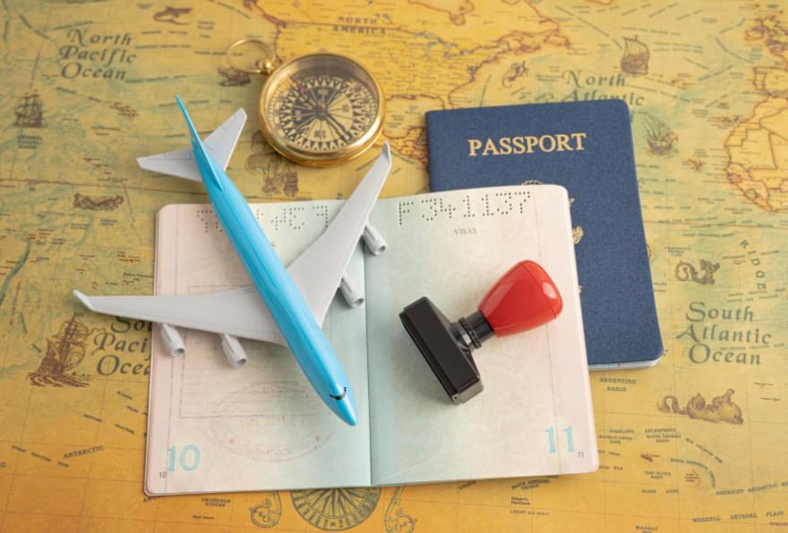 Passport and travel essentials were laid out to represent preparation for Cayman Islands visa requirements
