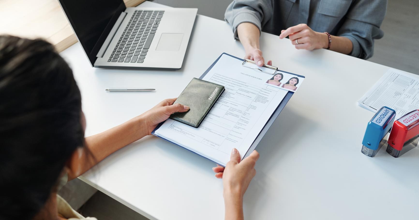 Professionals reviewing documents during a discussion about visa requirements for the Cayman Islands