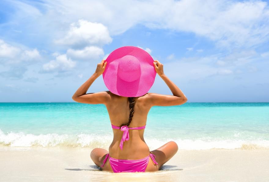 A woman relaxing on a beach chair, enjoying the serene views in Grand Cayman.