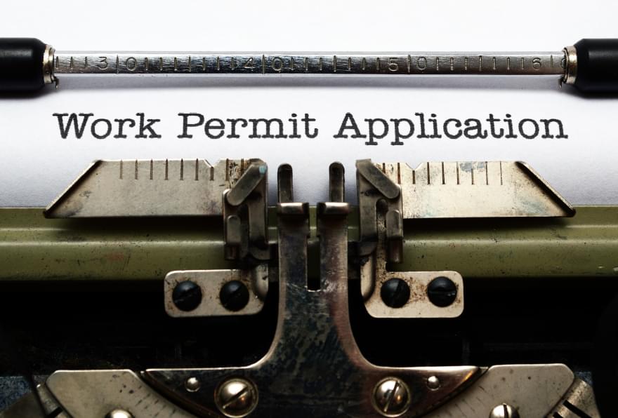 Close-up of a work permit application on a typewriter, illustrating the work visa for the Cayman Islands process