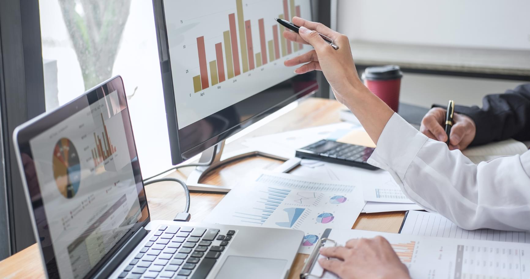 A businesswoman analyzing charts, representing strategies aligned with requirements for a Cayman visa