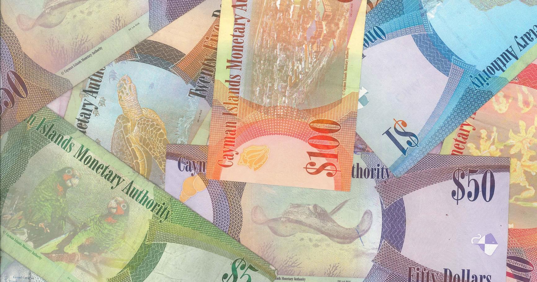 A mix of colorful Cayman Islands banknotes emphasizing the diversity of Cayman Islands money