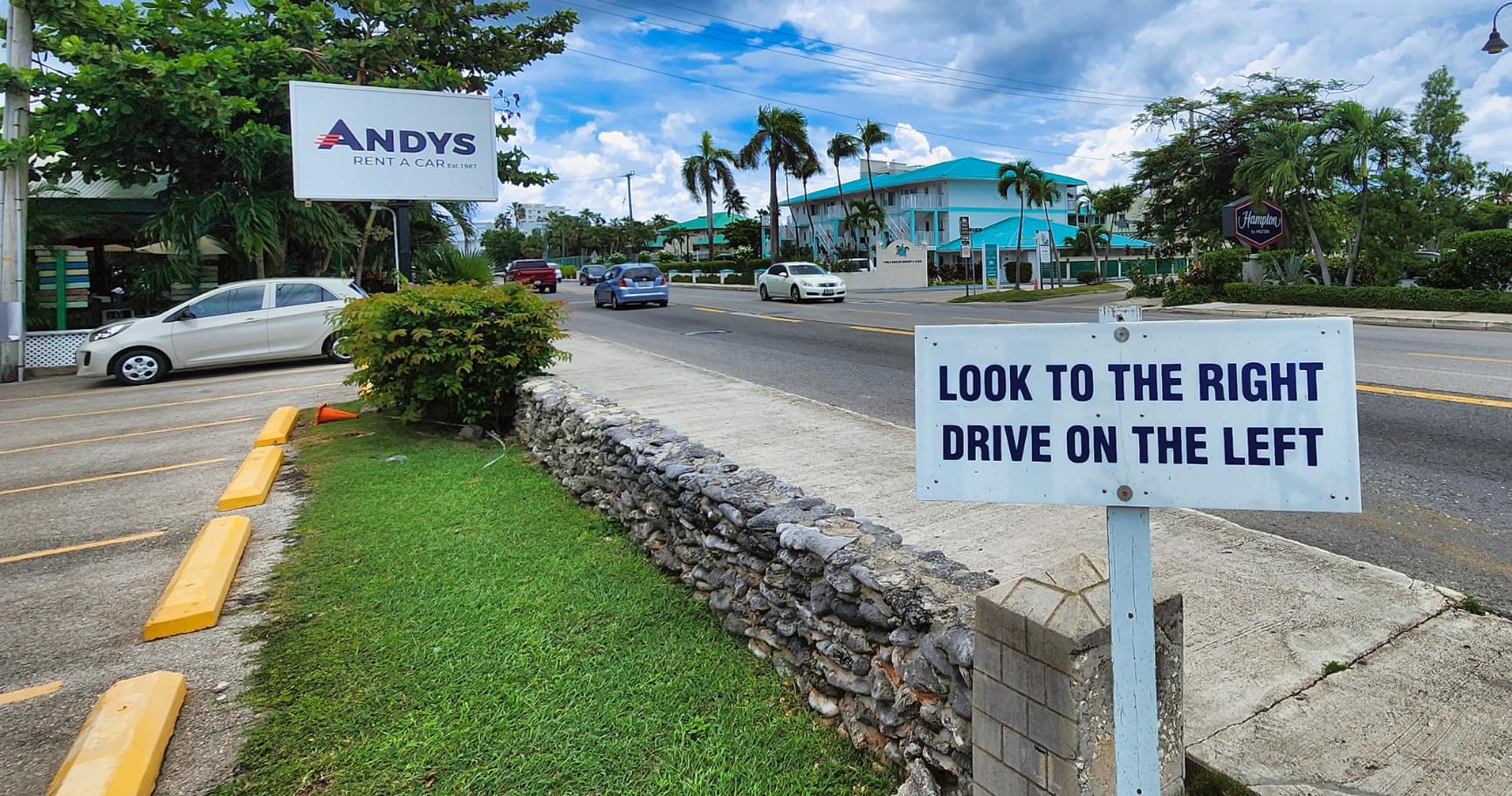 Road safety sign advising tourists about driving rules, reinforcing is the Grand Cayman safe for travelers