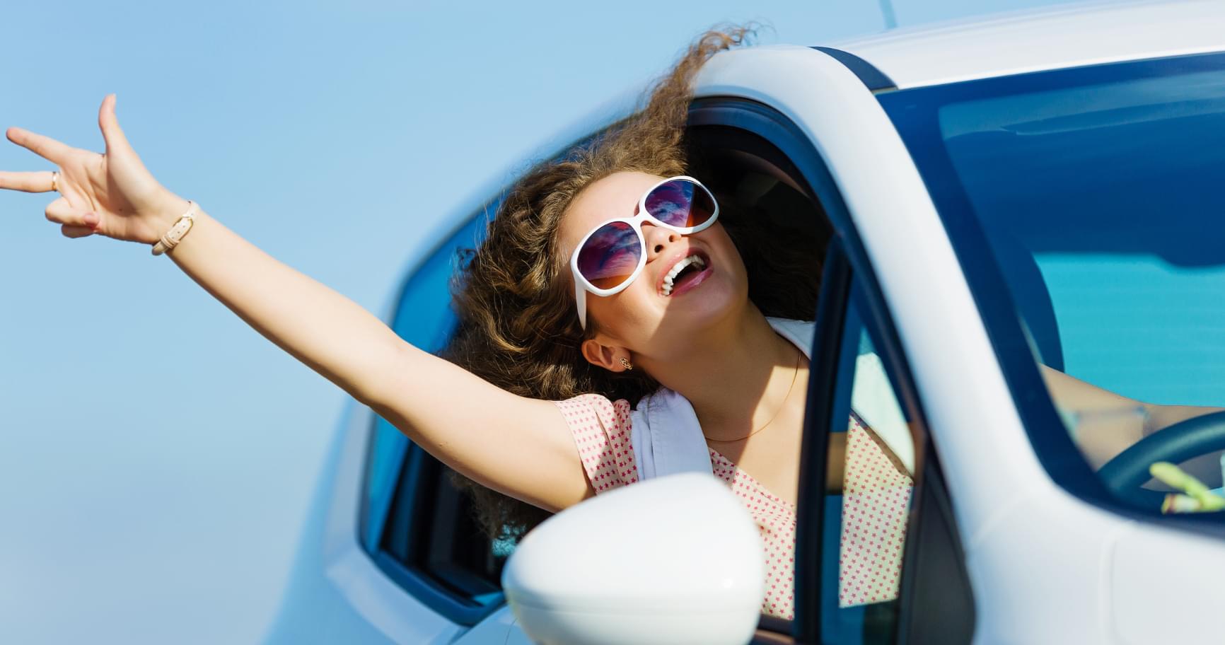 Woman driving a rental car, highlighting the convenience of Grand Cayman car rental