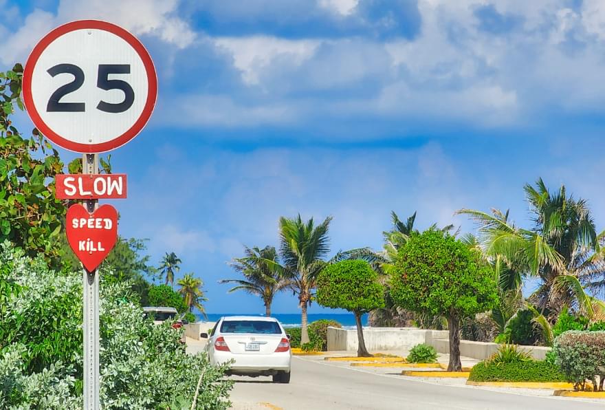 Speed limit sign advising tourists about driving rules with Grand Cayman Rental Cars