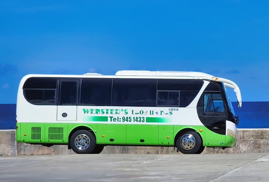 Green shuttle bus for excursions departing from the Grand Cayman cruise ship schedule