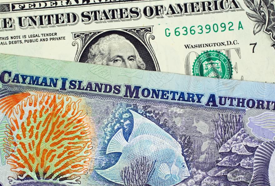 Cayman Islands currency and US dollars are displayed, showing the local exchange options