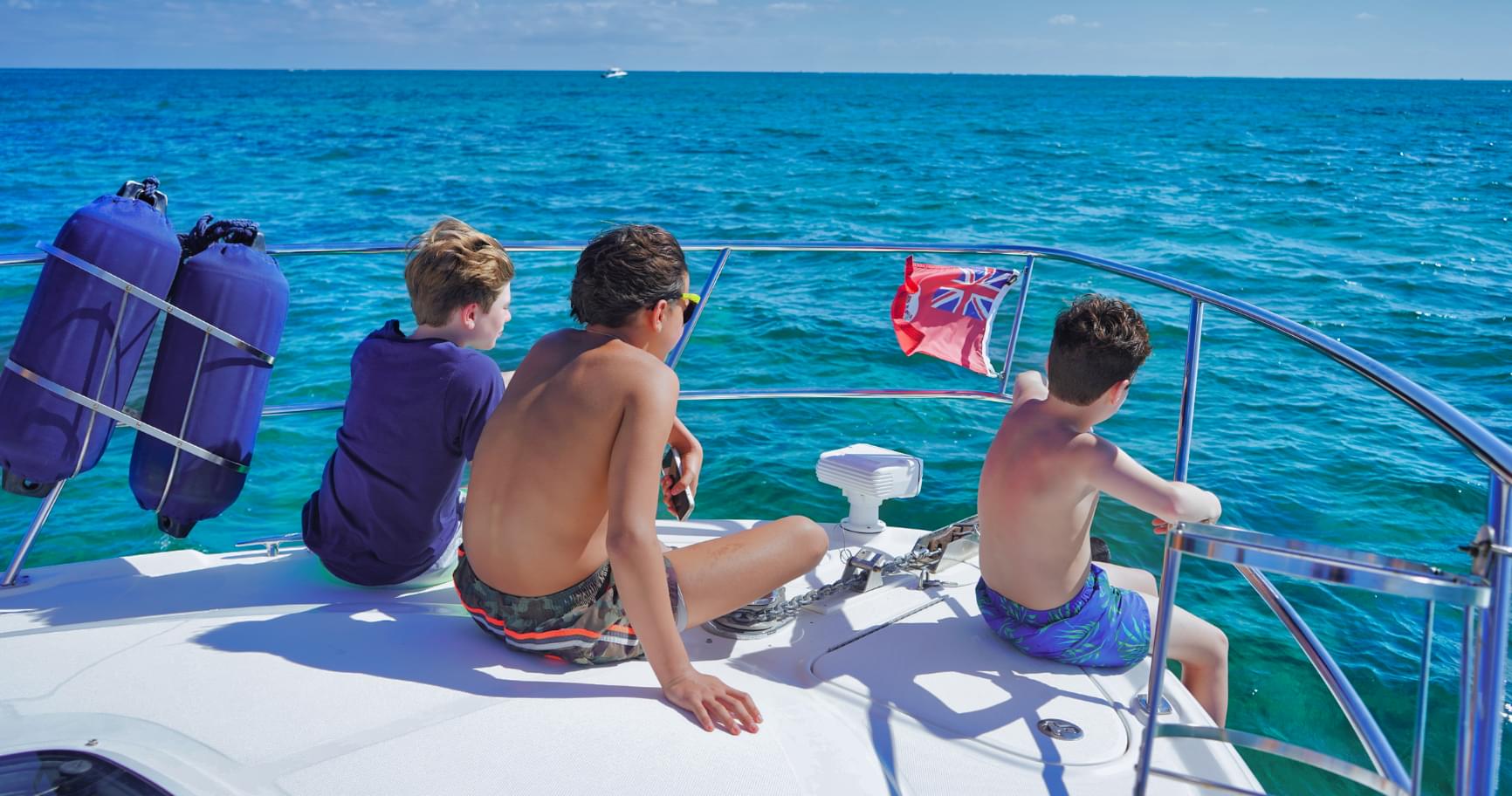 Family relaxing on a boat, enjoying a private tour near the Cayman island cruises