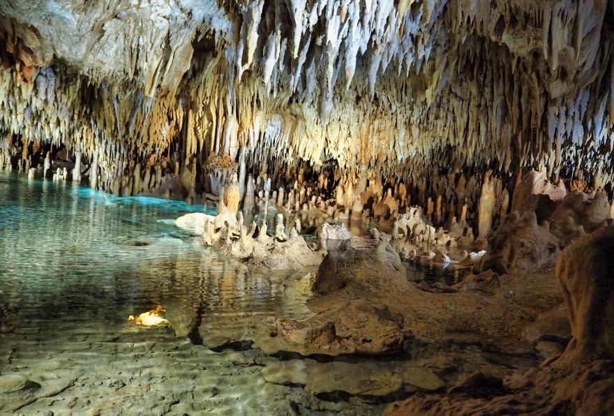 Stalactites and clear pools inside the Cayman Crystal Caves are a hidden gem for Cayman things to do.