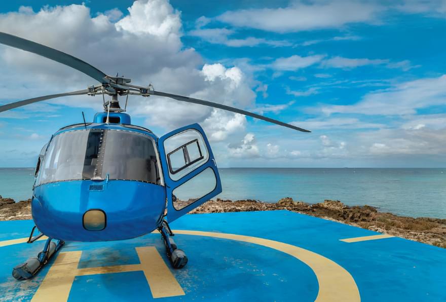 Helicopter parked in George Town, offering scenic aerial tours in Grand Cayman.