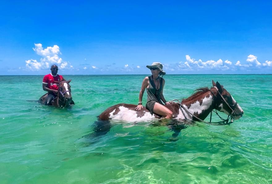 Horseback riding through serene beaches and shallow waters one of the things to do on Grand Cayman.