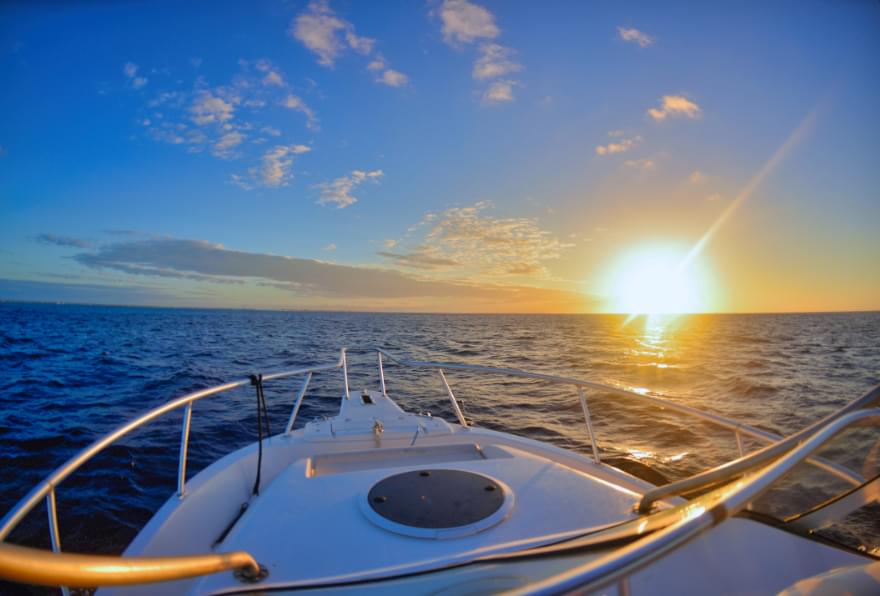 Sunset cruise on a luxury boat, gliding along the coastline with stunning views.