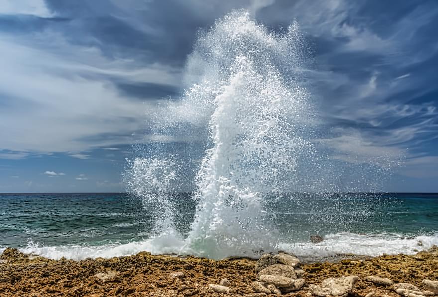 Dramatic wave spouts at the Grand Cayman Blow Holes, a natural spectacle.