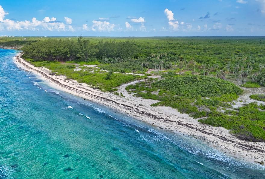 The secluded shoreline of Barefoot Beach in Grand Cayman is a tranquil escape and one of the free things to do in Grand Cayman.