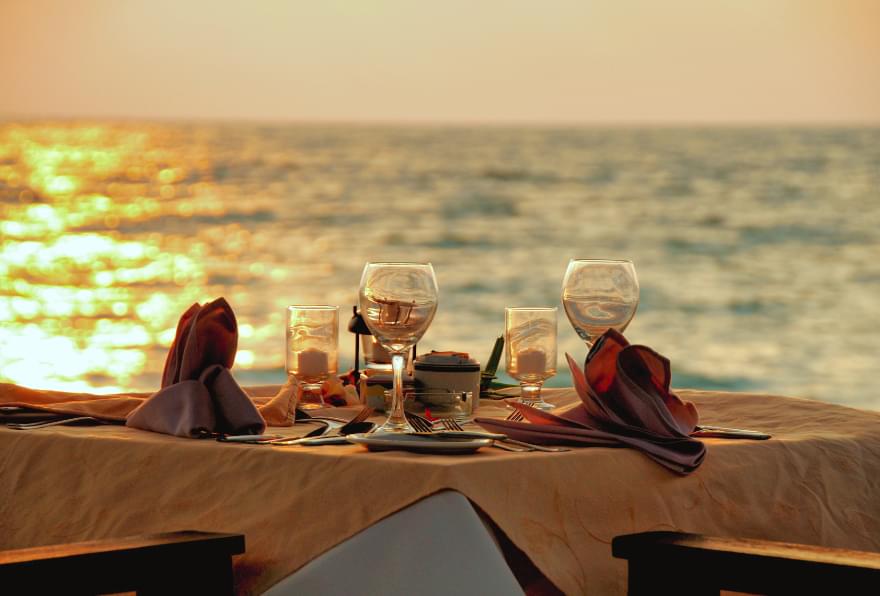 Sunset dinner on the beach with stunning ocean views in Grand Cayman.