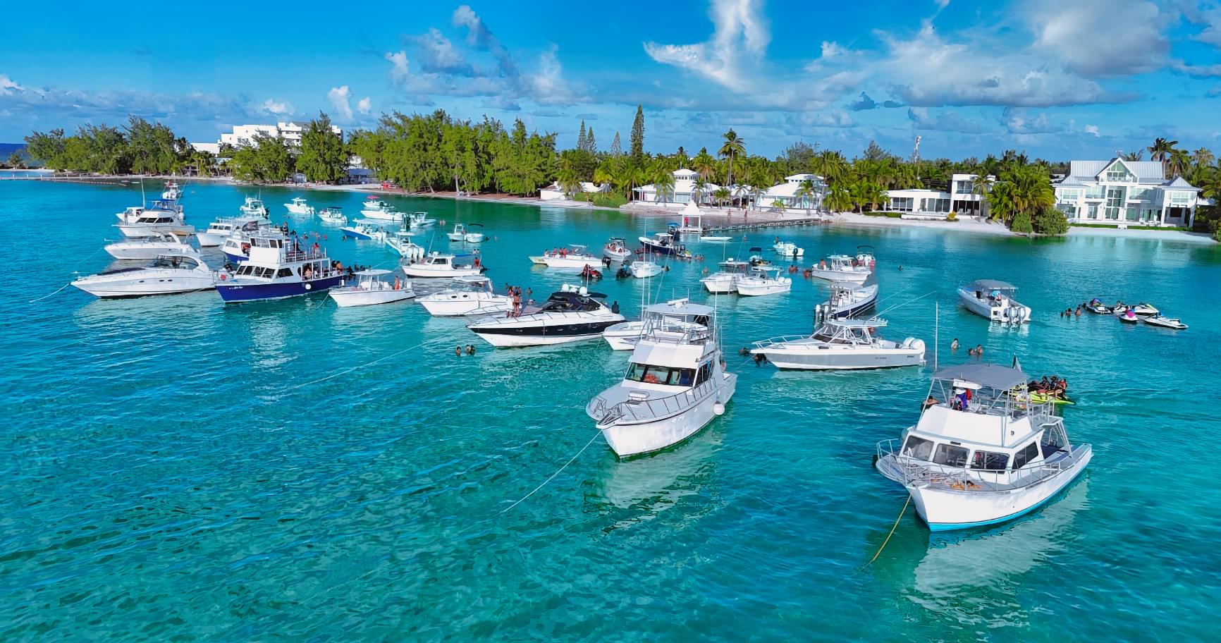 Boats at Rum Point, Grand Cayman, anchored near turquoise waters and popular for marine adventures