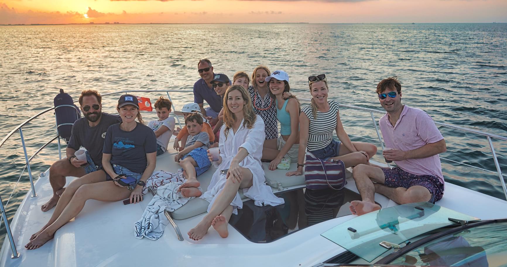 Group enjoying a private boat charter in Grand Cayman, one of the Grand Cayman private excursions