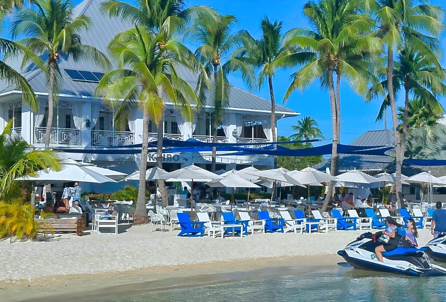 Lively dining scene at the beachfront bar in Grand Cayman, part of Cayman luxury excursions