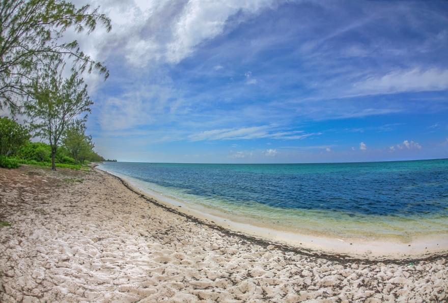 Secluded stretch of beach with crystal-clear waters, perfect for snorkeling excursions