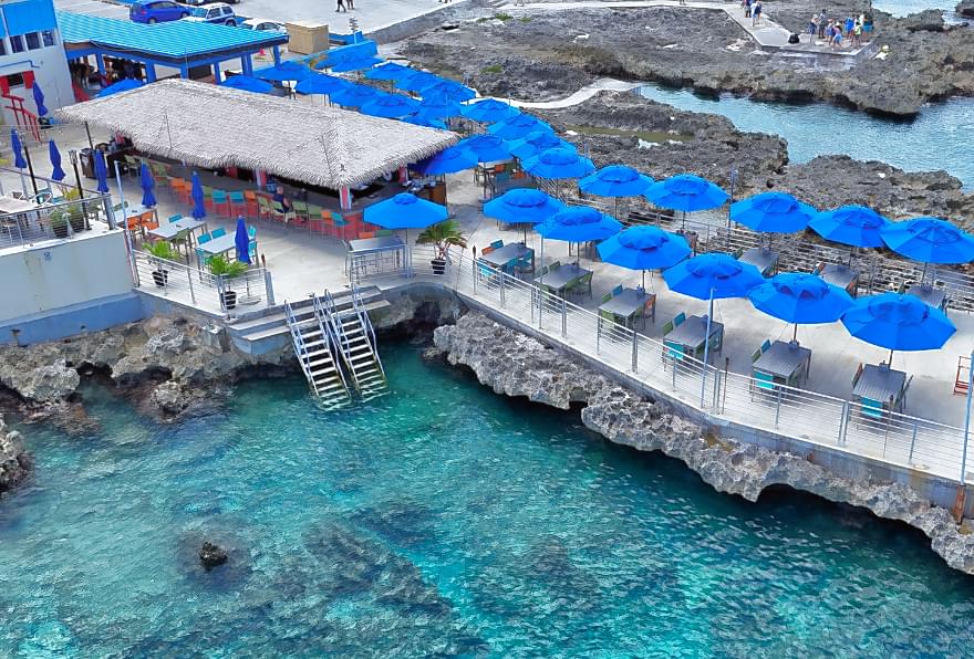 Oceanfront dining at Macabuca, a popular spot for sunset views and Grand Cayman best excursions