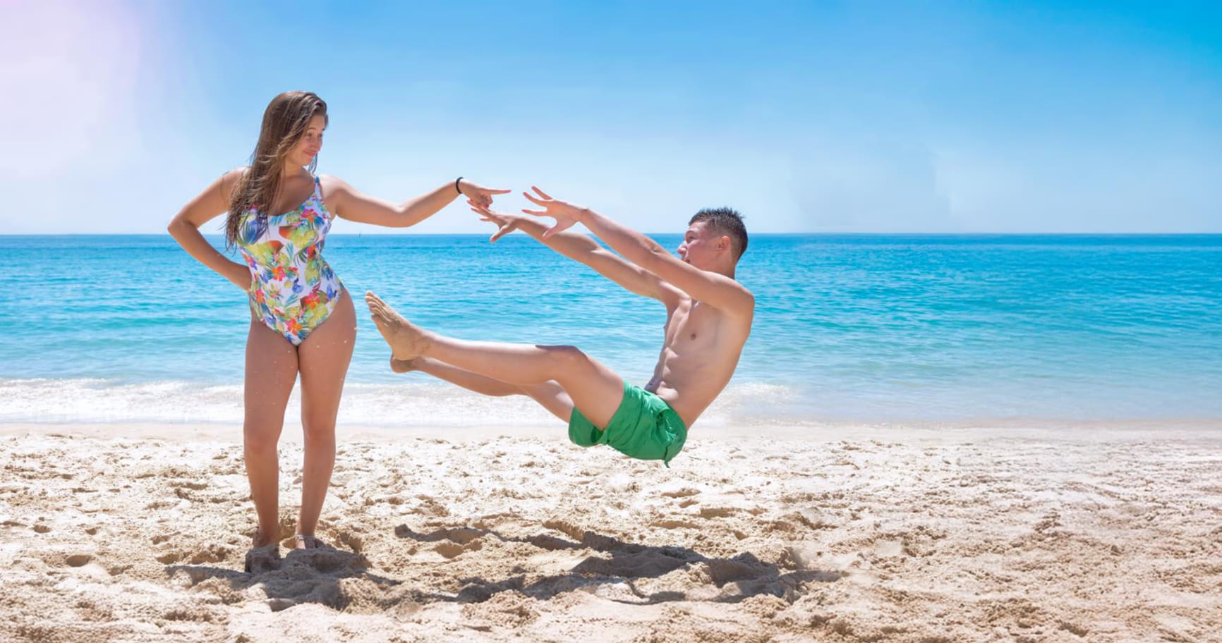 Couple enjoying playful moments on a pristine beach in Grand Cayman, ideal for romantic best Grand Cayman excursion