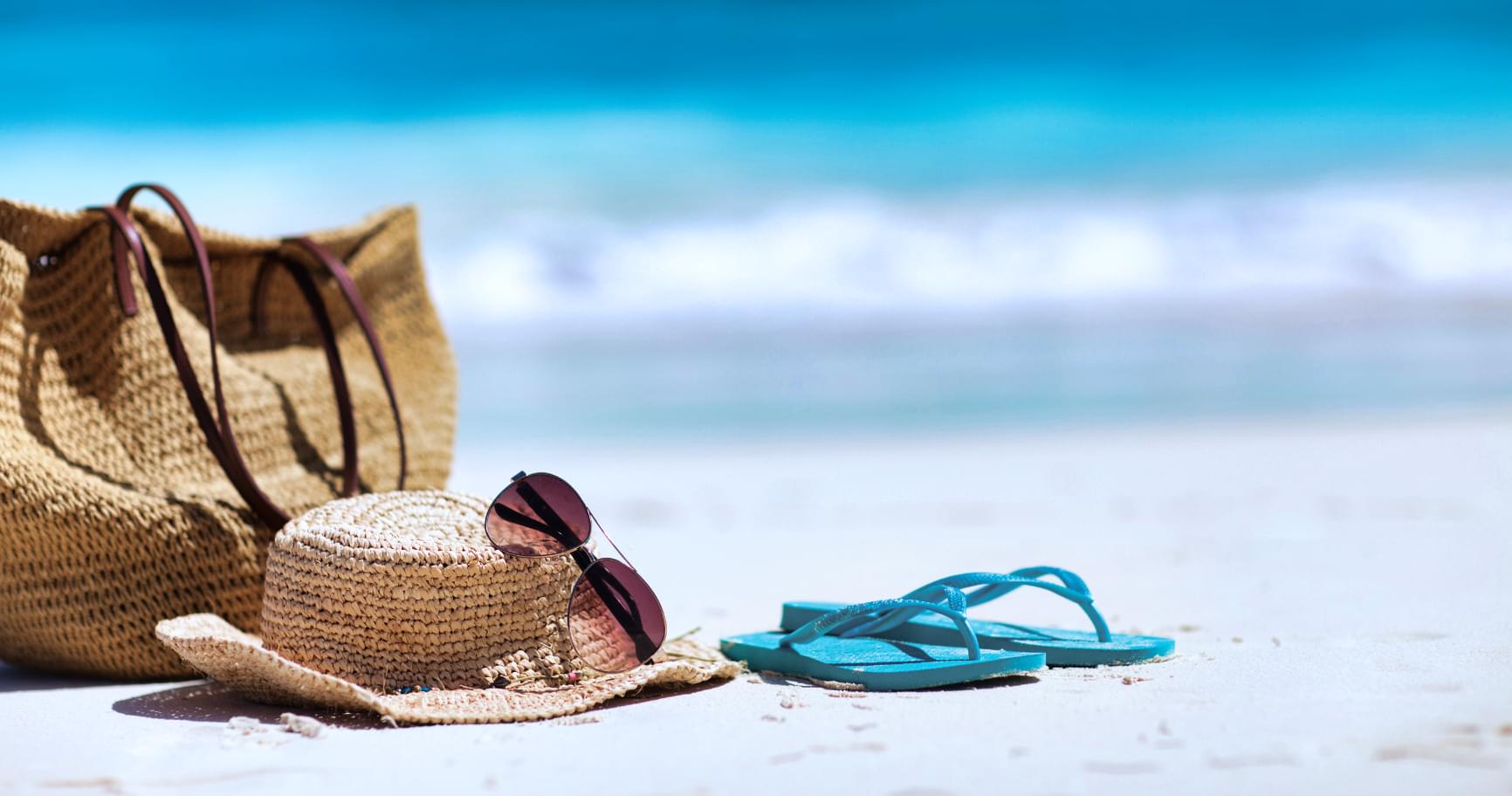 Beach essentials arranged on the sand in Grand Cayman, ready for a day of relaxation and excursions