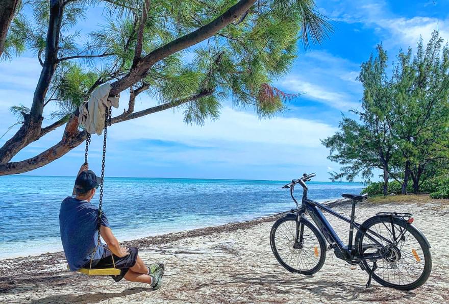 Biker enjoying coastal views, part of an eco-tour in best shore excursions in grand cayman