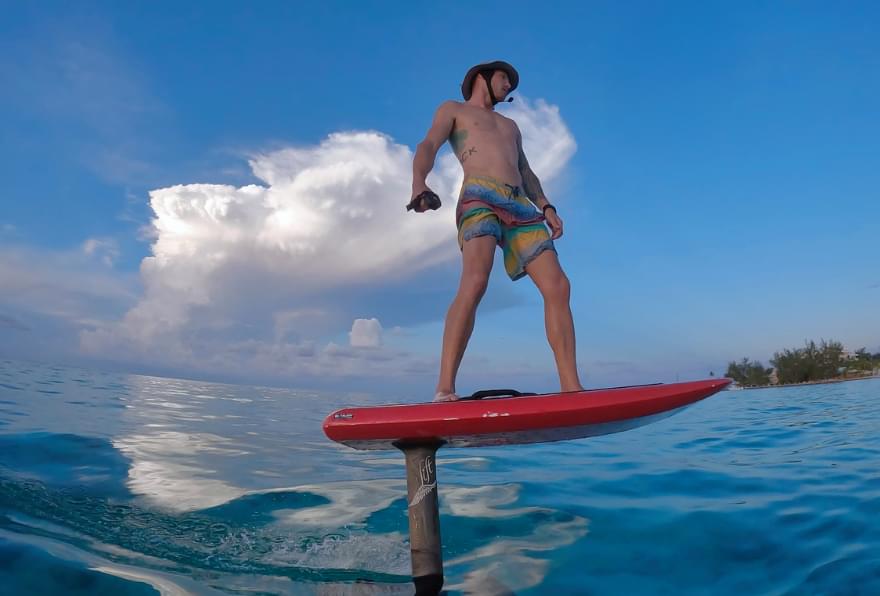 Gliding on an eFoil over turquoise waters, one of the most unique excursions in Grand Cayman with carnival