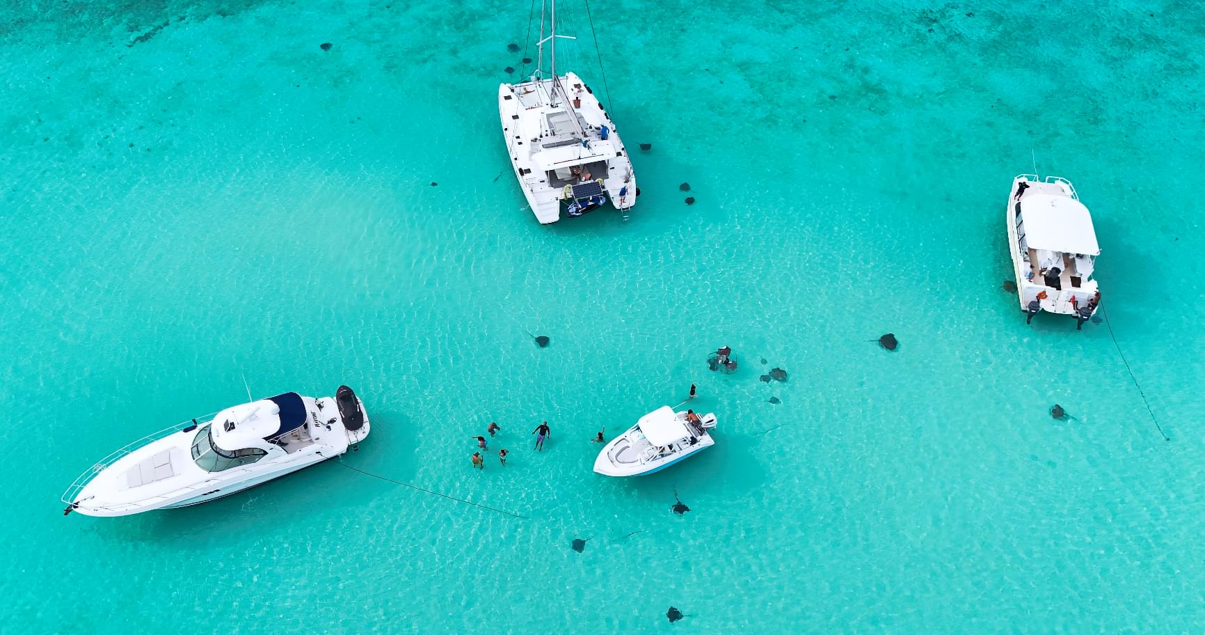 Boats anchored at Stingray City during a private boat charter in Grand Cayman.