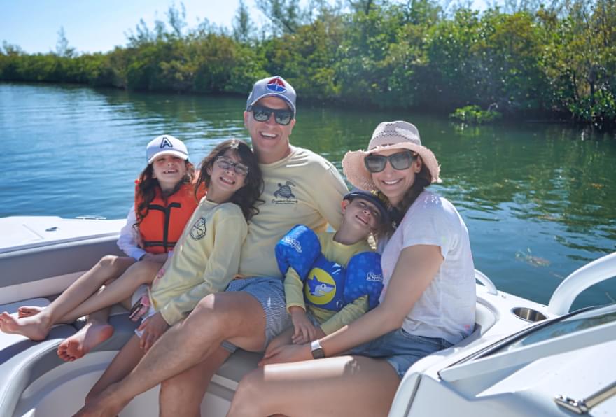 Family smiling on a private boat tour, perfect for a personalized Cayman adventure