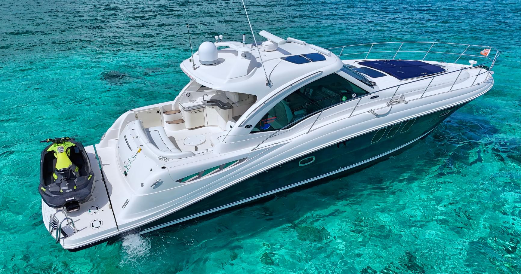 Luxury boat anchored in turquoise waters, highlighting a premium experience in Grand Cayman