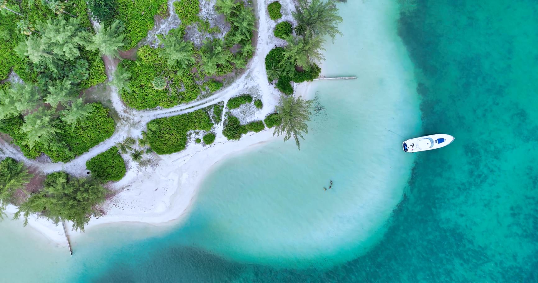 Aerial view of a secluded cove in Grand Cayman, showcasing the tranquility of Cayman luxury charters